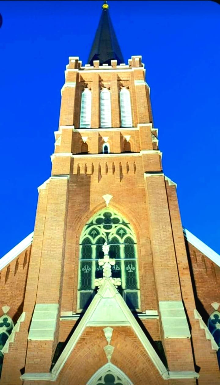 Church steeple against blue sky